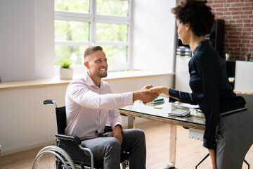 Businessman Shaking Hands With Disabled Businesswoman