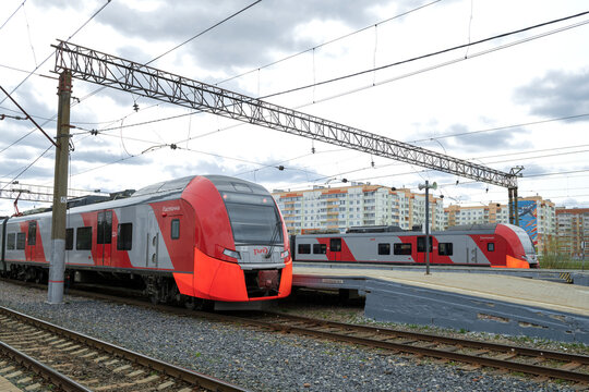 VELIKY NOVGOROD, RUSSIA - MAY 02, 2022: Two electric trains ES2G "Lastochka" on the railway station of Veliky Novgorod on a cloudy May day