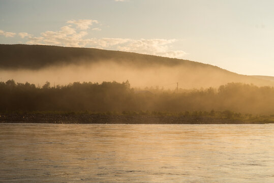 Midnight Sun Over a Misty River In the Far North of Finland