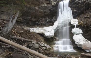 Troll Falls, Melting Ice Frozen Waterfall Cascade in Alberta Kananaskis Country, Canadian Rocky Mountains