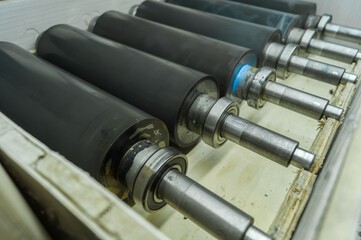 Used printing shafts for flexographic printing press. A set of rubberized knurling shafts in a...