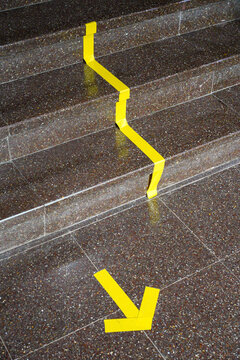 Yellow duct tape on the floor.
