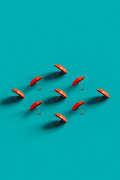 3d rendered red umbrellas in shape of rhombus