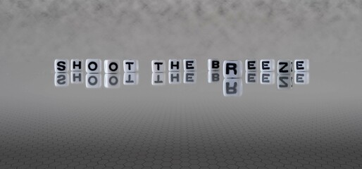 shoot the breeze word or concept represented by black and white letter cubes on a grey horizon...