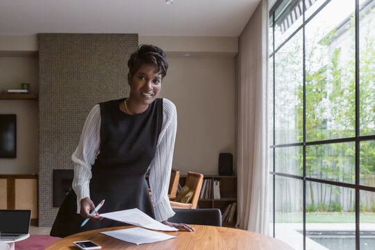 Portrait of a confident smiling professional woman at home
