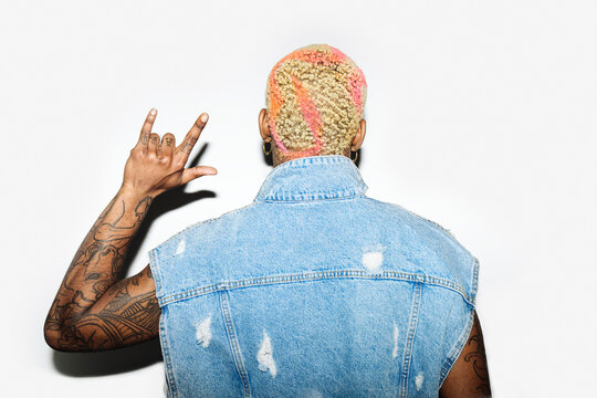 Anonymous Black man showing sign of the horns