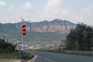 The cliff and Chinese lanterns on the side of the road