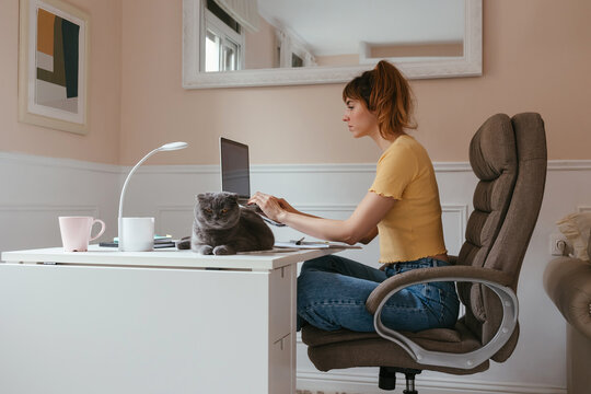 Female student using laptop at home