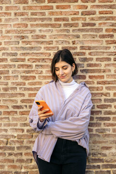 Young cool woman outdoors with cell phone