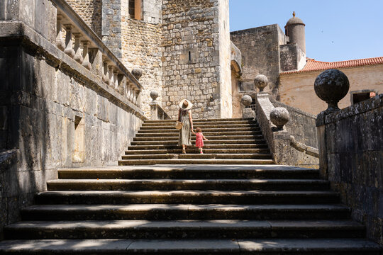 Traveling mom and little girl visiting a castle