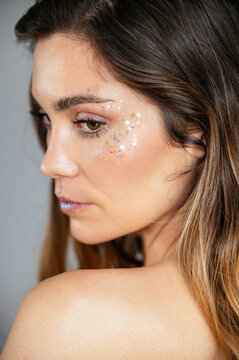 side view Young woman model with glitter on face