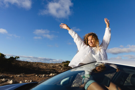 Happy woman traveling by car