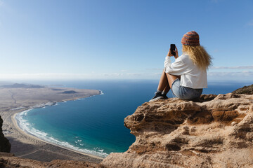 Woman taking photos with mobile phone