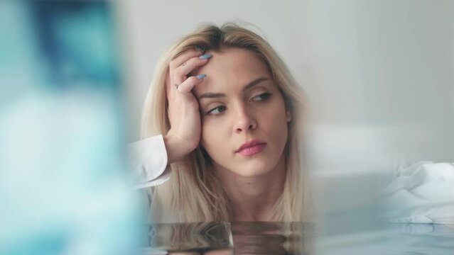 Sad woman. Stress frustration. Lonely sorrow. Creative portrait of depressed anxious tired emotion female in blurred mirror glass light background.