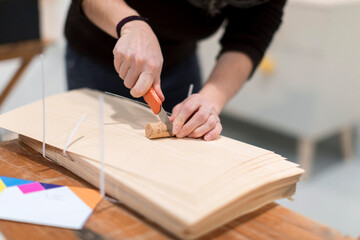 hands with a utility cutter.