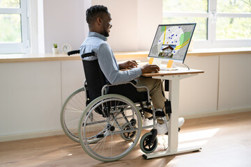 Worker In Wheelchair Searching For Real Estate On Computer