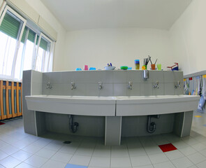 bathroom with ceramic sink without children in the daycare school