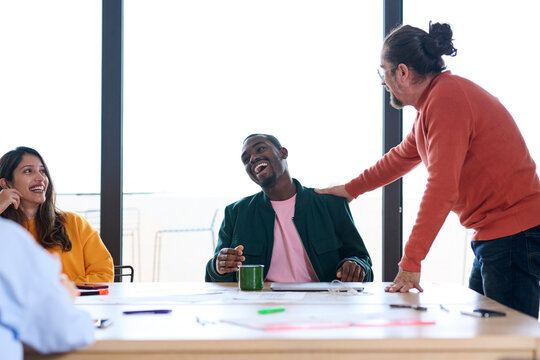 Male boss communicating with employees