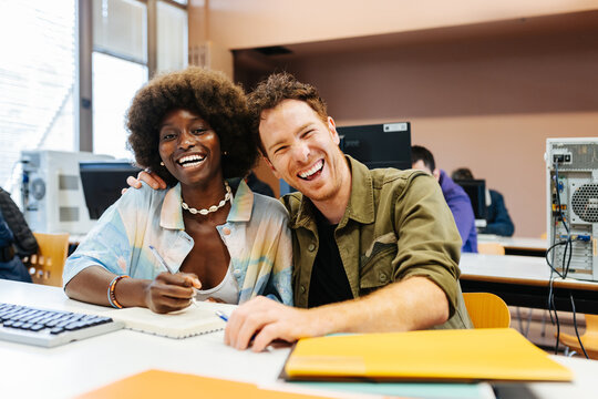 Cheerful afro woman having fun with her classmate