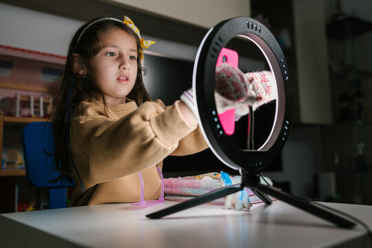 Cute child preparing smartphone for shooting video