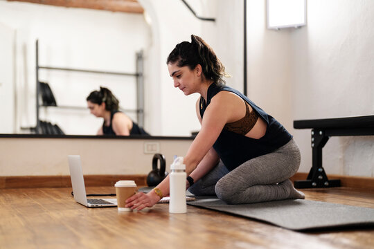 Sportswoman watching lesson during remote workout