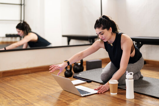 Sportswoman Opening Laptop Before Remote Training