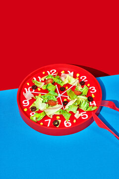 some salad served on a red clock