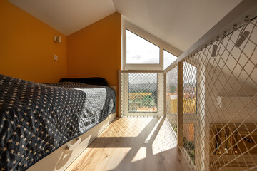Colorful two-level children's room with net railings