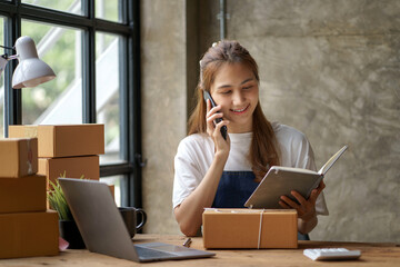 Online business owner are taking on the phone orders for customers, negotiating for delivery.