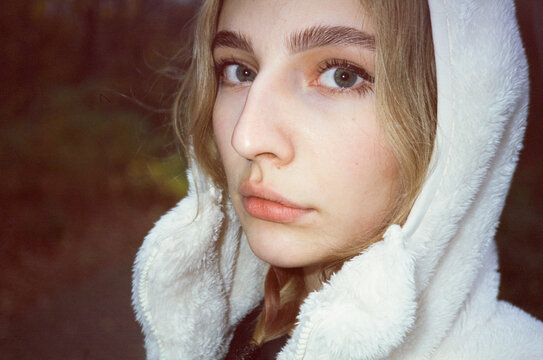 User generated content style portrait of a blond girl in white hoodie