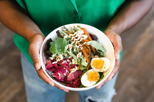 Man holding healthy grain bowl.