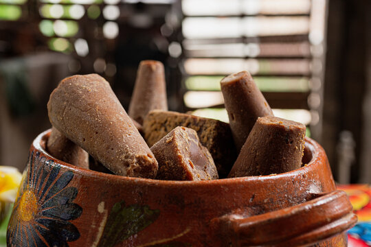 Piloncillo or sugar cane inside a clay pot in a house in Oaxaca