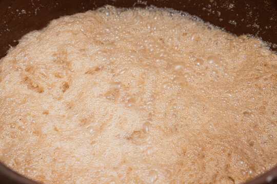 Closeup to a clay pot that has abundant cocoa or cacao foam