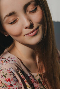 Beauty portrait of smiling woman with closed eyes