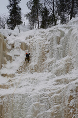 A Cliff Climber on Frozen Waterfalls in Finland