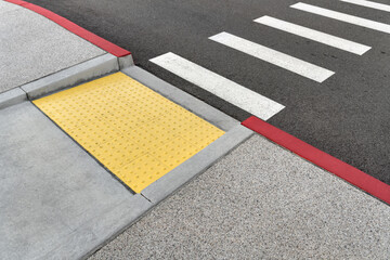 Closeup view at colorful crosswalk with tactile paving