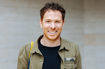 Young redhead student looking at camera