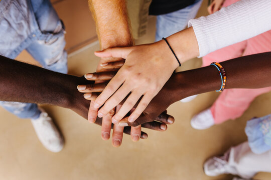 Diverse people stacking hands. Unity concept
