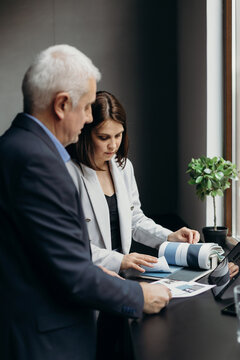 Businesspeople discussing samples near window