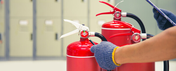 Fire extinguisher has engineer inspection checking pressure gauges of fire extinguishers to prepare...