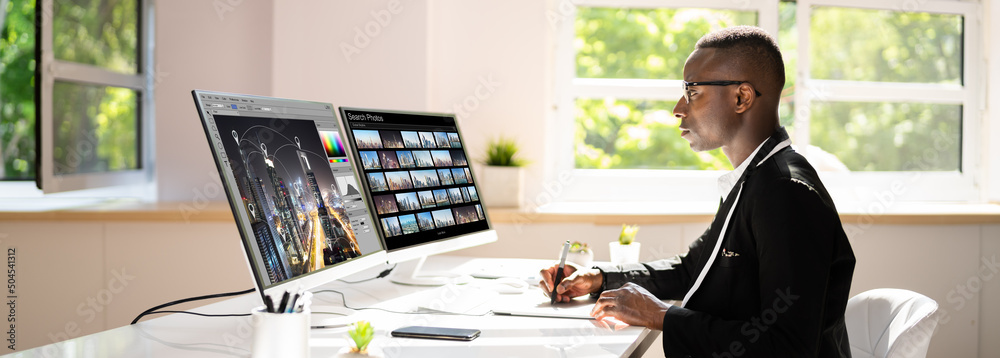 Poster Designer Editing Photos On Computer