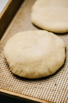 Pita bread on a baking sheet