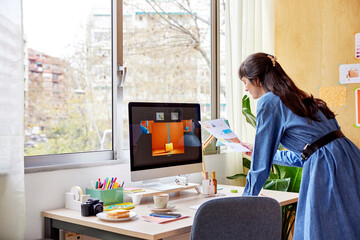 Brunette working on design project on computer