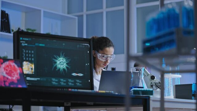 Bacteriology lab scientist working on research, using modern computer technology