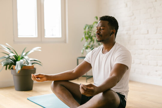 Male meditating at yoga studio