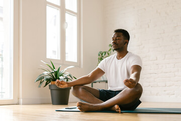 Male meditating indoors