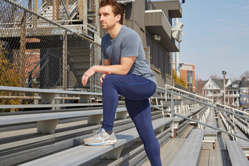 Young man stretches before run