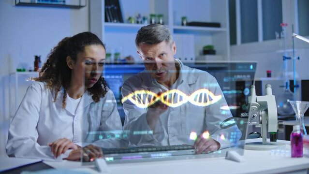 Two lab scientists looking at holographic monitor, making dna sequence analysis - Powered by Adobe