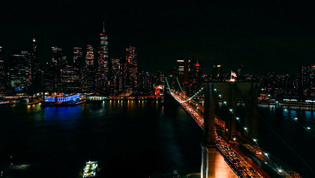Fototapeta Drone view of New York City and Brooklyn bridge at evening
