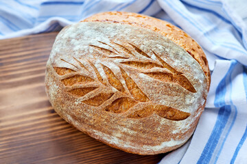Freshly baked homemade wheat bread on a wooden background. Close-up, selective focus